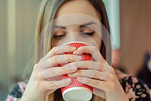 Coffee shop tasty hot morning beverage takeaway to go paper red cup tea enjoy face happiness hands holding concept. Close up view