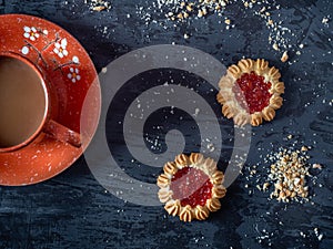 Coffee with shortbread cookies, curly cookies with strawberry jam