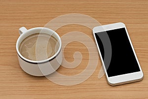 Coffee and smart phone on wooden table