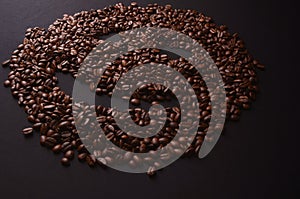 coffee smiley face made out coffee beans background, isolated over a gray background.