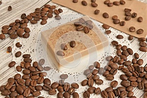 Coffee soap is hand-made on a napkin surrounded by coffee beans