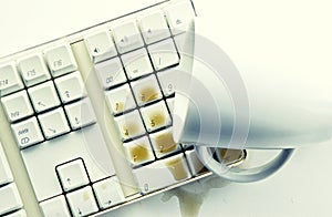 Coffee spilling over computer keyboard