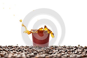 Coffee splash in brown disposable paper cup with coffee beans isolated on white.