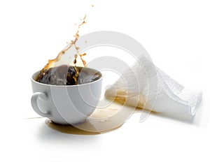 Coffee splash coming out of a white cup with spilled coffee