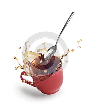 Coffee splash in a red mug on a white background