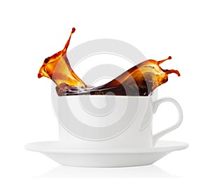 Coffee splash in a white cup with saucer