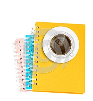 Coffee on stack of ring binder book or notebook isolated on whit