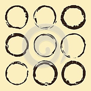 Coffee stain set. Brown ring blots isolated on beige background. Vector illustration