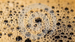 Coffee surface texture. Foam bubbles in detail. Aromatic hot drink