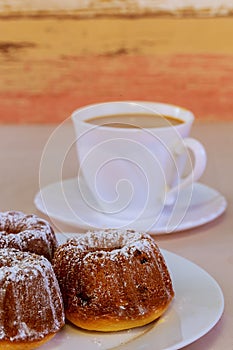 Coffee and sweet chocolate toffee cake. A cup of latte coffee