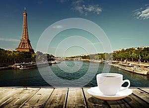 Coffee on table and Eiffel tower in Paris
