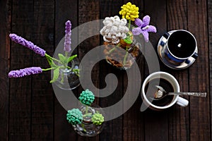 Coffee table with handmade flower by crochet, coffee cup, amazing artwork