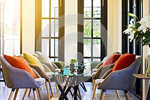 Coffee table set and modern chairs with colorful pillows