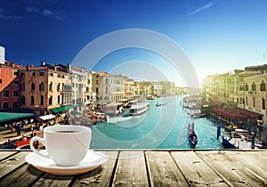 Coffee on table and Venice in sunset time
