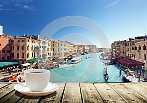 Coffee on table and Venice in sunset time