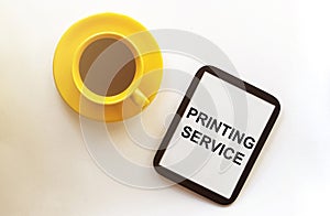 Coffee and tablet with text Printing Service on the white background