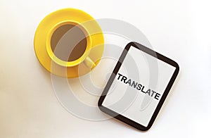 Coffee and tablet with text Translate on the white background