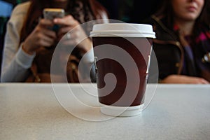 Coffee takeout cup on a table