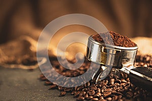 Coffee tamper,coffee press is made of stainless steel and roasted coffee beans from coffee roaster on black background,tool tamper