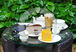 Coffee, tea, chocolate crape cake and orange cake