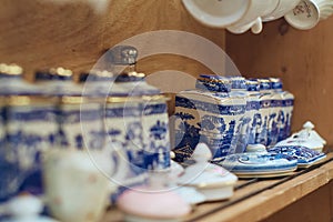 Coffee and tea shop decoration with shelves displaying blue and white porcelain tea sets.