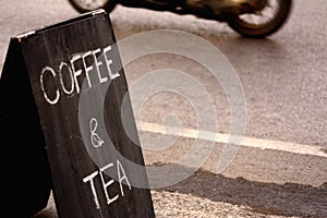 Coffee and tea sign on the side of road