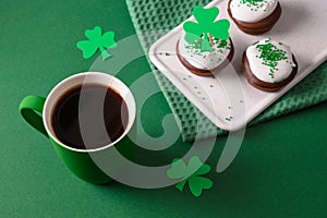 Coffee and three cupcakes for celebration St Patricks Day.