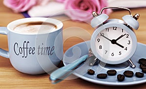 Coffee time with alarm clock and espresso cup in vintage colors