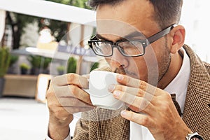 Coffee time. Sucessful businessman enjoying in a cup of coffee photo