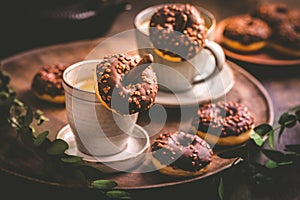 Coffee time - two cups of Caffe Americano with small chocolate donuts photo