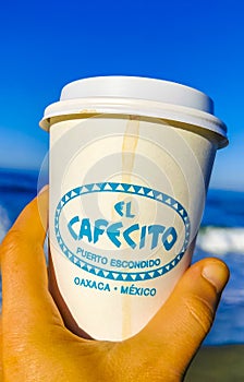 Coffee to go mug on the beach sand sea waves