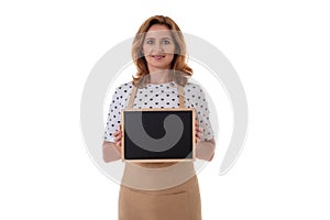 Coffee waitress holding a chalk board. Beautiful woman in barista apron holding empty blackboard on white background isolated