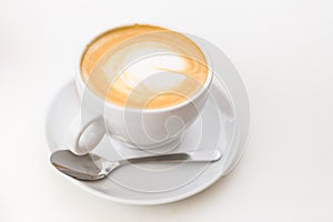 Coffee on a White Background. Coffee in a white cup with latte art. Flat lay, copy space