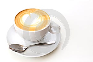 Coffee on a White Background. Coffee in a white cup with latte art. Flat lay, copy space