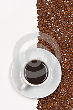 Coffee in white cup on saucer placed cofee beans