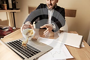 Coffee in white cup spilling on the table in the morning working day at office table