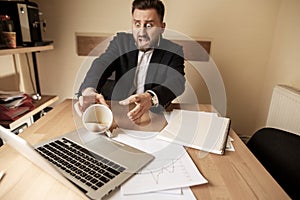 Coffee in white cup spilling on the table in the morning working day at office table