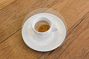 Coffee in white cup on wood table