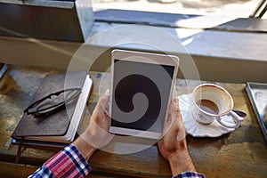 Coffee and wireless freedom. a man using a digital tablet at a cafe.