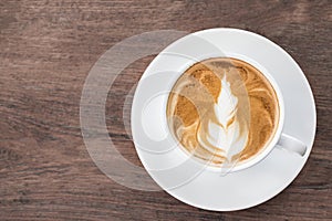 Coffee withe cup latte art on wooden.copy space for your text