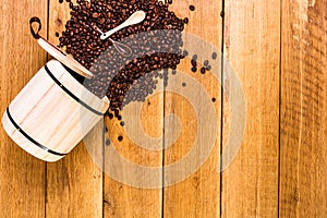 Coffee wooden barrel, roasted coffee beans on wooden background, coffee spoon, top view, copy space for text, close up coffee