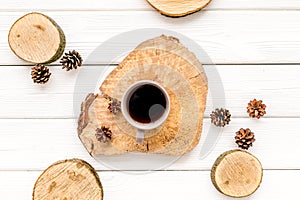 Coffee, wooden stumps and pine cones for blog background top view