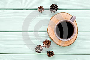 Coffee, wooden stumps and pine cones for blog background top view space for text