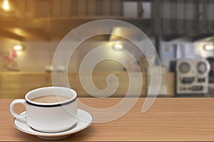 Coffee on wooden table with abstract blur of counter bar