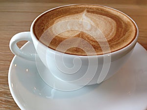 Coffeecup of with heart shape art on foam photo