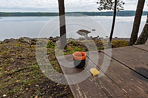 Coffeecup at a table near a lake