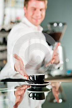 Coffeeshop - barista presents coffee photo
