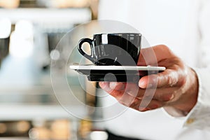 Coffeeshop - barista presents coffee or cappuccino photo