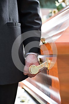 Coffin bearer carrying casket at funeral