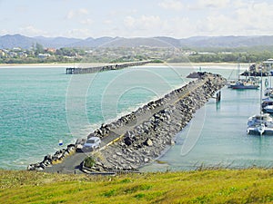 Coffs Harbour Marina rock breakwall and ocean timber jetty photo